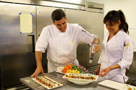 Chef and Sous Chef working on preparing a delicious course of food